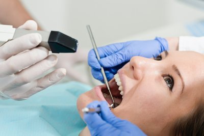 Doctors applying dental - veneers to women patient
